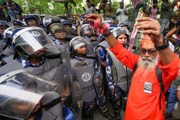 During a BJP-organized protest in Kolkata to mark the one-year anniversary of the rape and murder of a trainee doctor at RG Kar Medical College, a man held up bangles and 'rakhis' as part of the demonstration.(Image Source: PTI)
