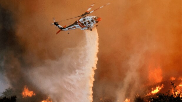 Helicopters deployed: Cattle ranches near the fire were forced to evacuate as the state authorities had engaged aircrafts to conduct water drops on rapidly spreading flames. (Photo Source: Reuters)