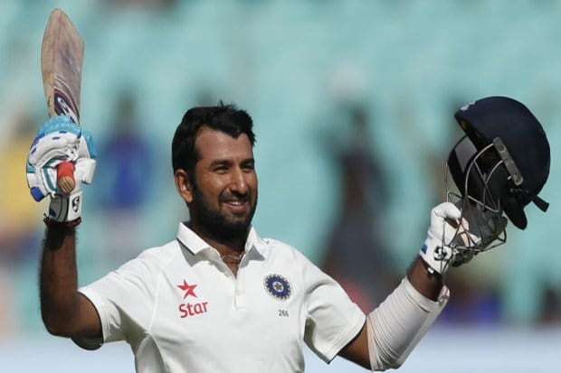 Cheteshwar Pujara celebrates his century on the third day of the first Test against England in Rajkot. (Image Source: AP)