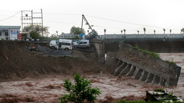 Vehicles stuck in the damaged portion of the Fourth Tawi Bridge after relentless rainfall, at Bhagwati Nagar, in Jammu.  (Photo Source: PTI)