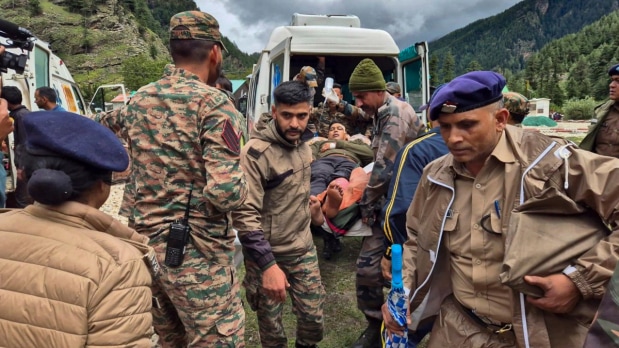 In this image released by @airnewsalerts via X on Aug. 7, 2025, an injured victim of the flash flood in Uttarkashi is being carried to an Ambulance by the Indo-Tibetan Border Police (ITBP) in coordination with the Indian army. (Photo Source: @airnewsalerts on X via PTI)