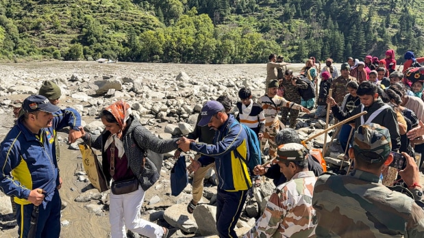 This image, captured on August 8, shows people being evacuated from flash flood-hit Dharali, in Uttarkashi, by the Indian Army and SDRF in a joint operation.  (Photo Source: PTI)