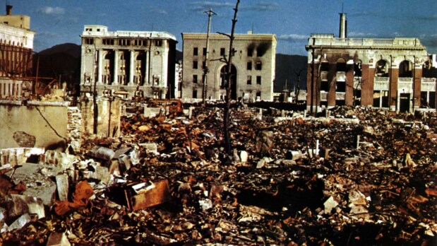  The headquarters of Geibi Bank (second building from the left) as seen from Saiku-machi (now part of Ote-machi, Naka Ward), hypocenter of the atomic bombing. To the right of the bank building is the Hiroshima branch of the Sumitomo Bank. The building in the foreground on the right is the Hiroshima branch of the Norinchukin Bank. This photo was taken by the U.S. military in November 1945.  (Photo Source: United States Army - Returned Materials)
