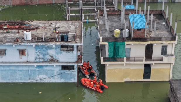 NDRF personnel rescue people at an area inundated with the Ganga river water, in Prayagraj, Uttar Pradesh. (Photo Source: PTI)