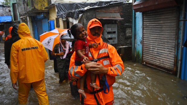 A Team of the  5th battalion of the National Disaster Response Force (NDRF) has been deployed at Kurla's Kranti Nagar to conduct a flood water rescue operation. (Photo Source: Indian Express)