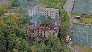 Fire crews work at the scene of Woolton Hall in Liverpool on Wednesday (Photo: AP)