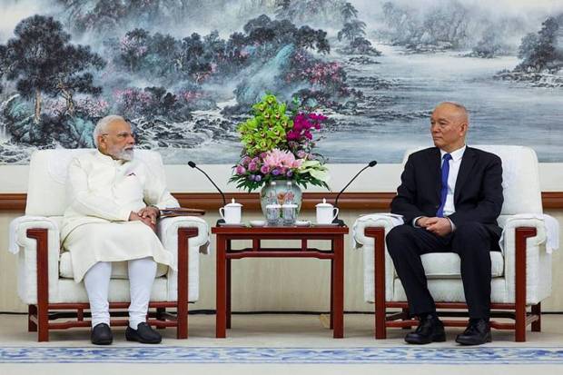 PM Modi with with Cai Qi, member of the Standing Committee of the Politburo of the Chinese Communist Party. He pointed out that cooperation between India and China benefits 2.8 billion. (Photo source: PTI)