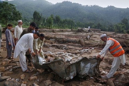 Local residents search through an area covered with mud and debris (AP Photo) Local residents search through an area covered with mud and debris (AP Photo)