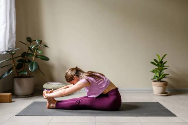 Paschimottanasana (Seated while bending forward)- This comfortable pose squeezes the belly and calms the nervous system. It is considered ideal for releasing stress related to digestive discomfort. (Photo source: Canva)