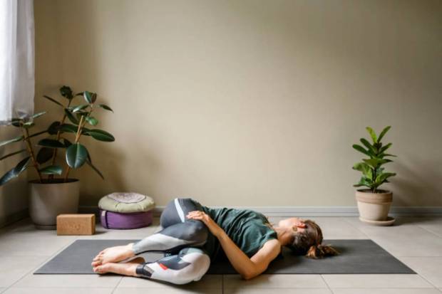 Spinal Twist (laying back or seated)-Twisting the torso massages the internal organs and boost encourages bowel movement. This yoga pose helps in reducing the tension in the gut and in providing relief in case of bloating. (Photo source: Canva)