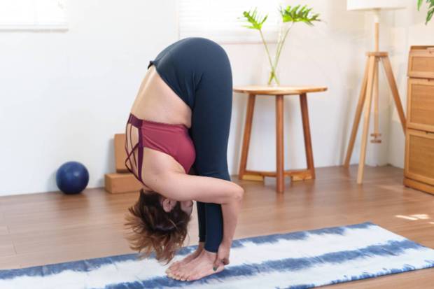 Uttanasana ( Standing with a forward bend)- A simple forward bend that boosts uplifts circulation and abdominal organs. This pose can aid in relieving pressure from the back as well from the belly. (Photo source: Canva)