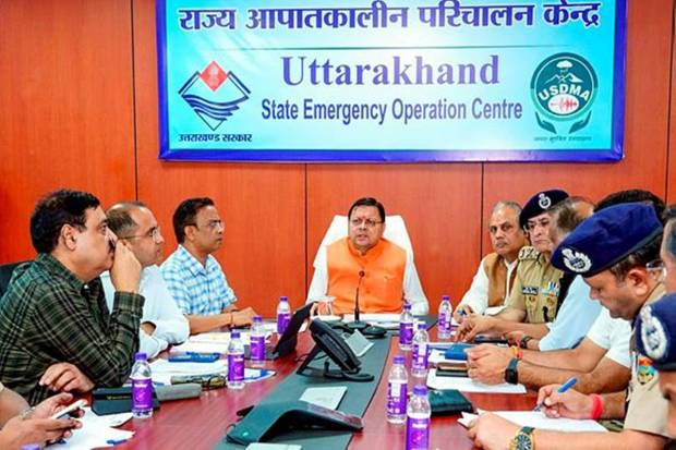 Chief Minister Pushkar Singh Dhami heading the meeting related to rescue operations. Chinook and Mi-17 helicopters have been kept on standby for airlifting the supplies once the weather gets clearer. (Photo source: PTI)