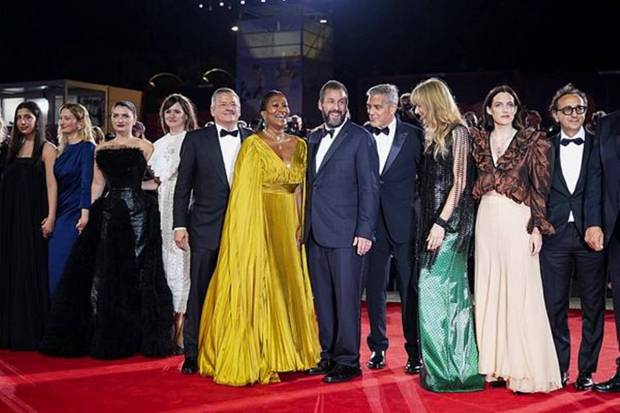 Sadie Sandler, from left, Alba Rohrwacher, Eve Hewson, Emily Mortimer, Ted Sarandos, Nicole Avant, Adam Sandler, George Clooney, Laura Dern, Riley Keough, and Giovanni Esposito pose for photographers at the red carpet for the film 'Jay Kelly' during the 82nd edition of the Venice Film Festival, Italy, on Thursday, Aug. 28, 2025. (Photo source: AP)