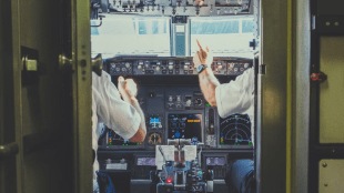British Airways grounded one of its pilots after he left the cockpit door of a Boeing flight open so that his family could watch him maneuver the plane from London to New York.