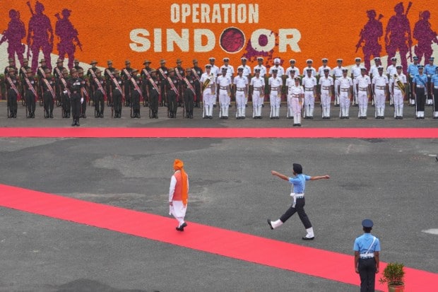 Indian Prime Minister Narendra Modi, center left, inspects a joint military guard of honor as he arrives to address the nation from the rampart of the 17th century Mughal-era Red Fort monument during the country's Independence Day celebrations in New Delhi. (Image source: PTI)