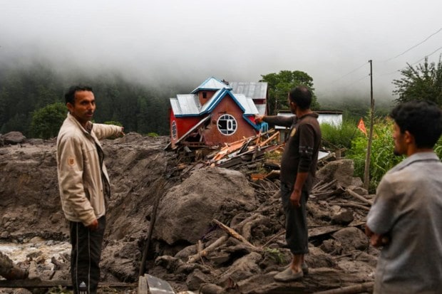 People show damaged structures at an affected area following a cloudburst in Kishtwar district, Jammu and Kashmir. (Image source: PTI)
