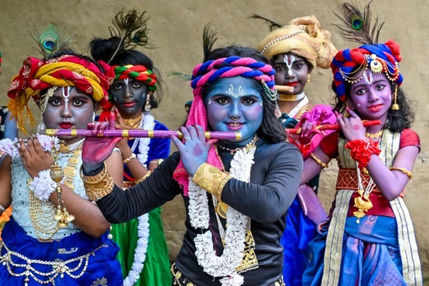 Young boys dressed up as Lord Krishna on the eve of the 'Janmashtami' festival, in Nadia. (Image source: PTI)