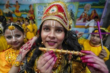 Students dressed as Lord Krishna and his divine consort Radha during celebrations of Janmashtami festival at a school in Amritsar. (Image source: PTI)