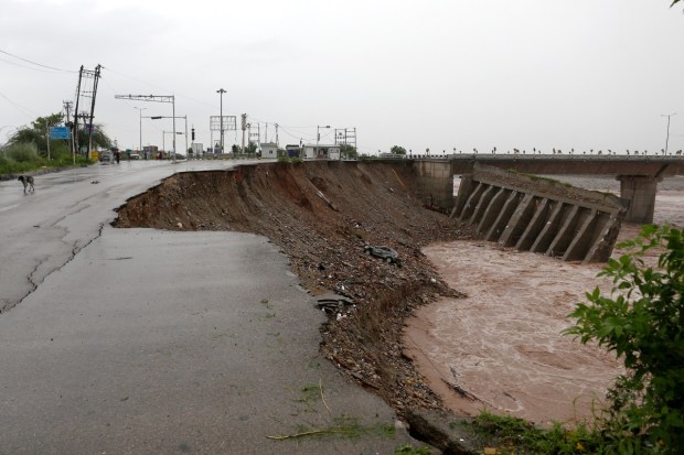 A portion of a bridge washed away amid rise in the Tawi river water level due to heavy rainfall. (Image source: PTI)
