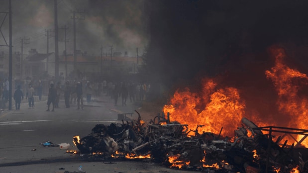 Protesters burn vehicles and tires during a protest in Kathmandu. (Photo Source: Associated Press)