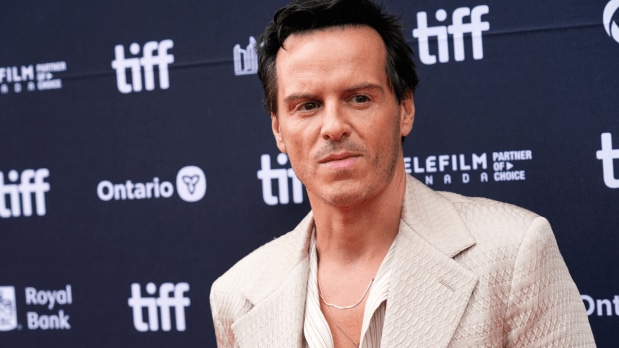 Andrew Scot, the beloved preist from 'Fleabag' greets fans and flashes a grin while arriving for the 'Wake Up Dead Man' premiere at the Princess of Wales Theatre, adding wit and warmth to TIFF’s celebrations. (Photo: Associated Press)