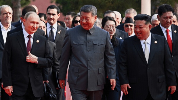Chinese President Xi Jinping, center, and foreign leaders including Russia President Vladimir Putin, center left, and North Korean leader Kim Jong Un, center right, walk to Tiananmen Rostrum ahead of a ceremony. The three leaders were photographed walking together towards the ceremony, a striking image broadcast on giant screens in the capital where they were joined by heads of state from Pakistan and Indonesia. (Photo Source: Associated Press)