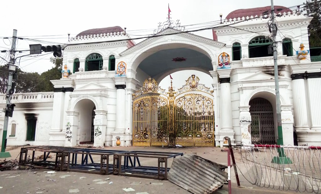 Debris lies on a road outside the Singha Durbar complex following the violent protest against the Government over alleged corruption (ANI Video Grab) Debris lies on a road outside the Singha Durbar complex following the violent protest against the Government over alleged corruption (ANI Video Grab)
