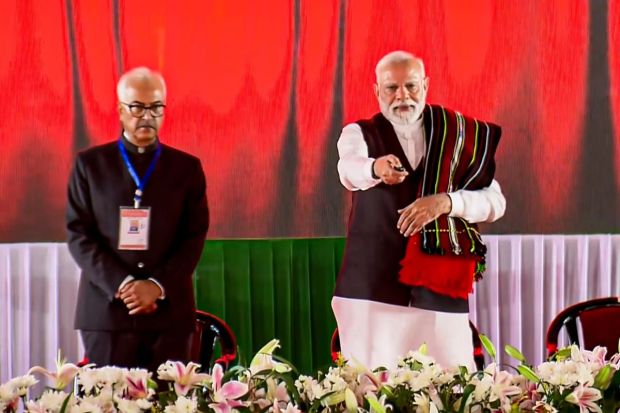  Manipur Governor Ajay Kumar Bhalla stands next to PM Modi as he virtually lays the foundation stone and inauguration of development works, in Churachandpur, Manipur. (Image: PTI)