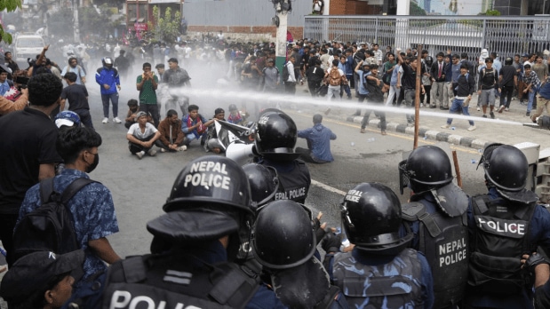 Riot police use a water cannon on protesters outside Parliament. (Photo Source: Associated Press)
