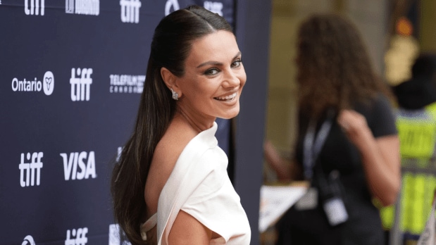 Mila Kunis poses for photographers and greets fans at the premiere of 'Wake Up Dead Man: A Knives Out Mystery' at the Princess of Wales Theatre during the Toronto International Film Festival on Saturday.