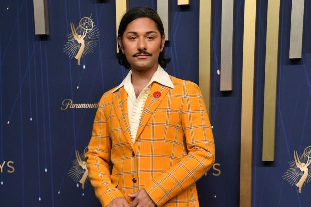 Primary colours seemed to reign the Emmys Red Carpet 2025 as Mark Indelicato wore a yellow plaid suit with a knit shirt. Fans were confused what to rate this outfit. (Image: AP)