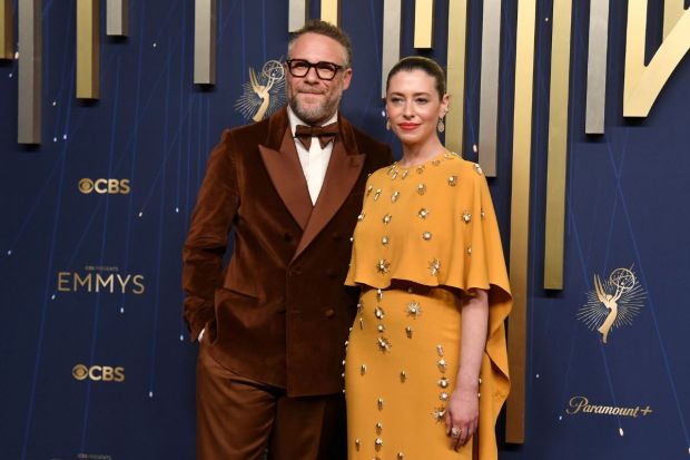 Seth Rogen registered multiple wins for Emmys 2025. The power couple was sporting a velvet brown suit from Eltro. While his wife,  Lauren Miller Rogen, complemented the outfit, it seemed rather uninspired. (Image: AP)