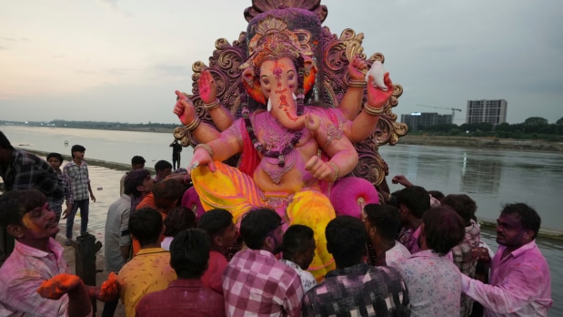  Hindu devotees carry an idol of the elephant-headed Hindu god Ganesha to immerse in the banks of the river Sabarmati during the ten-day-long Ganesh Chaturthi festival in Ahmedabad.