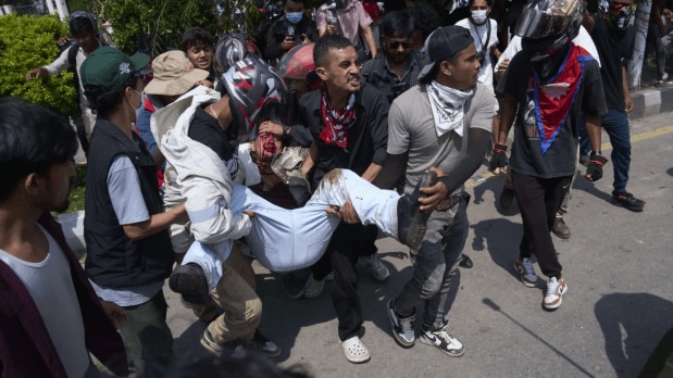 An injured protester is taken to hospital by his friends during a protest on September 9. (Photo Source: Associated Press)