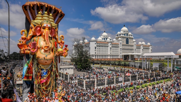 People take part in a procession for immersion of an idol of Lord Ganesha as part of the Ganesh Chaturthi festival celebrations, in Hyderabad on Saturday.