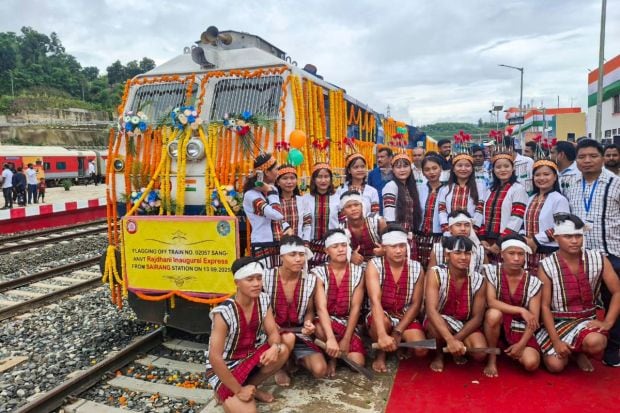 Several artists pose next to the Sairang-Delhi Rajdhani Express. Later today, PM Modi is set to arrive in Guwahati, and 1200 artists will commemorate Bharat Ratna Bhupen Hazarika's centennial birth anniversary with a 12-minute musical tribute. (Image: PTI)