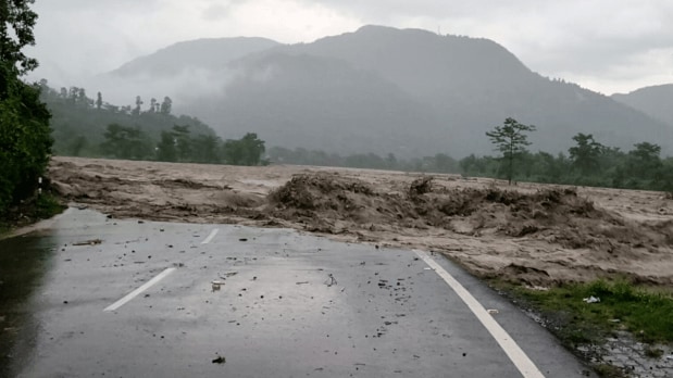 A portion of a road gets washed away amid heavy floods in Dehradun that were triggered by a cloudburst on Monday night. (Photo Source: PTI)