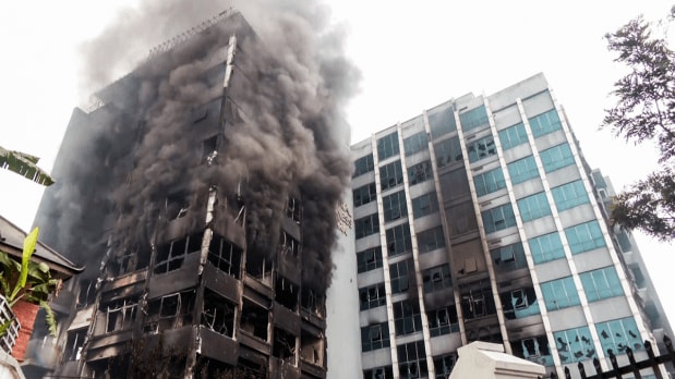 Smoke billows out from the Kantipur media group's headquarters, which was set on fire by Protesters amid the violent protest against the Government over corruption. (Photo Source: Associated Press)