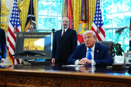 US President Donald Trump speaks to members of the media in the Oval Office of the White House.