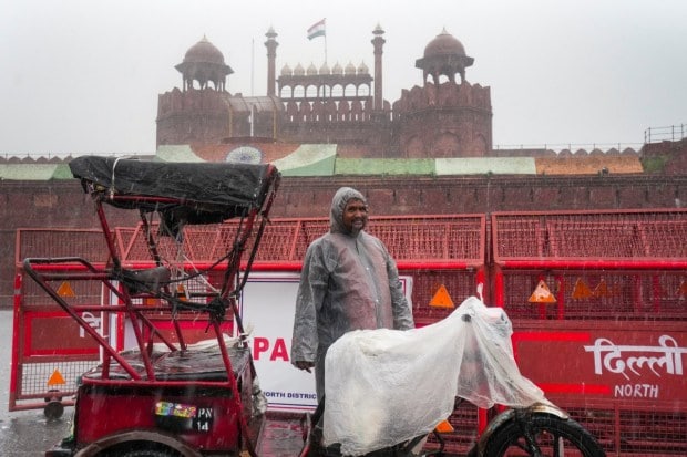Heavy showers drenched the national capital today, offering respite from the humidity but also disrupting the ongoing festive season. While the rain turned streets into waterlogged stretches and slowed traffic, it also created hurdles for preparations and celebrations across the city. From rickshaw pullers waiting in the drizzle to visitors shielding themselves with umbrellas at heritage sites, Delhi wore a soaked yet striking look. The downpour painted a mix of charm and challenge, capturing both the beauty of the monsoon and the difficulties it brought during the festive rush. (Image: PTI)