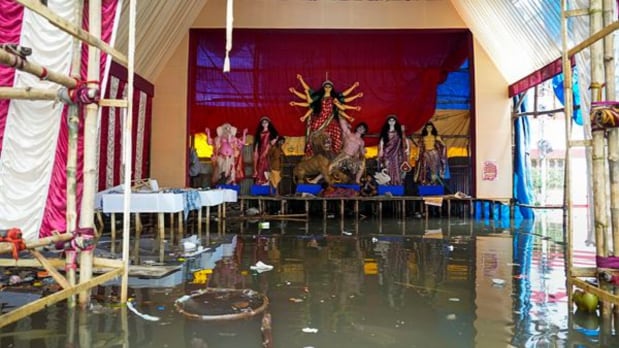Idols of Goddess Durga were placed on raised structures as rainwater inundated pandals ahead of the Durga Puja festival. (PTI)