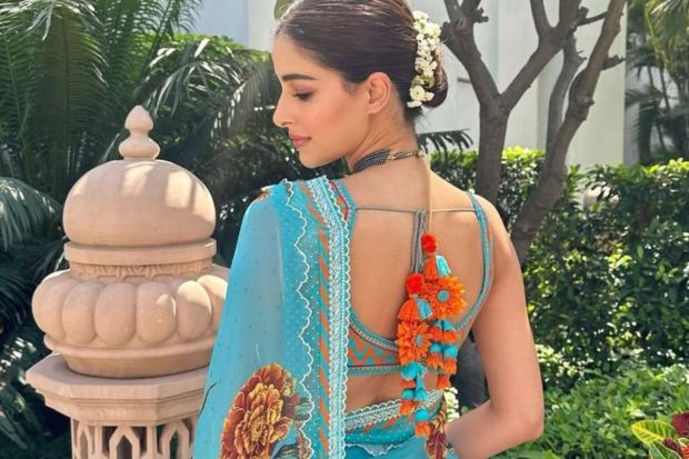 The blouse that the actress is pictured wearing here, is a unique design that can inspire Gen Zs who are tired of the same boring traditionals. A unique tassel like Ananya's or an uncommon colour combination can really help to make an outfit stand out. She adds flowers to her hair for that slight oomph. (Image source: Pinterest)