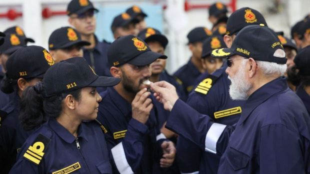 PM Modi was also seen offering sweets to Navy personnel. “Spending this occasion with our brave sailors has filled me with new energy and fresh enthusiasm,” he captioned the post on X. (Image Source: @narendramodi official account on X)