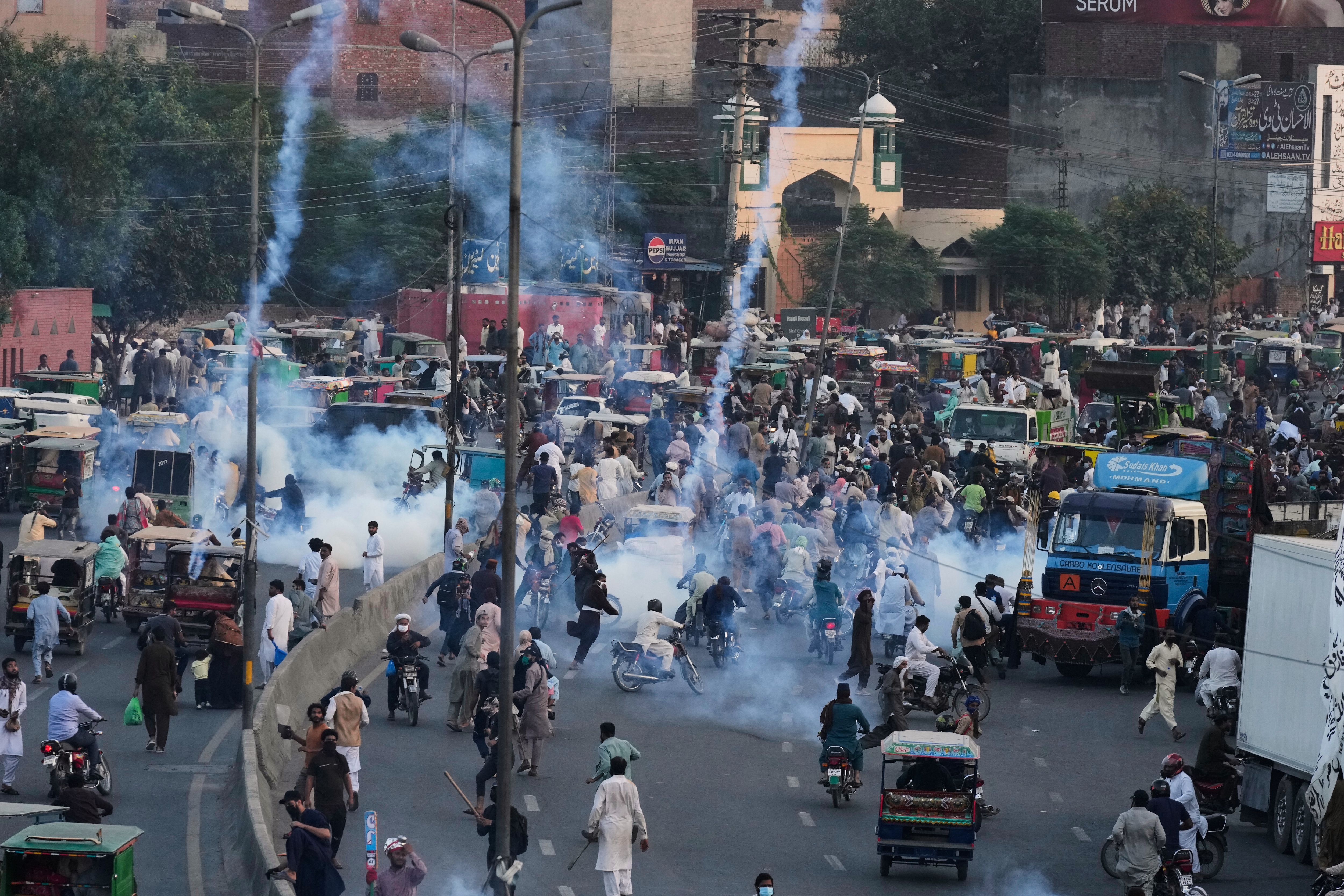 Police fire tear gas shells to disperse supporters of Islamist party 'Tehreek-e-Labbaik Pakistan' during their pro-Palestinian march toward the capital Islamabad, in Lahore, Pakistan, Friday, Oct. 10, 2025. AP/PTI(AP10_10_2025_000312A)