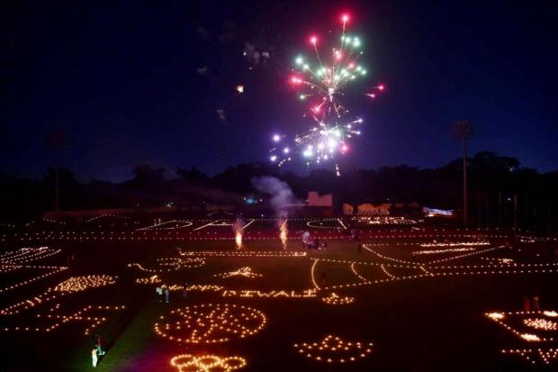 Athletes and members of a sports complex celebrate Diwali in a ground by lighting candles and firecrackers, at Madan Mohan Malviya Stadium in Prayagraj. (ANI)