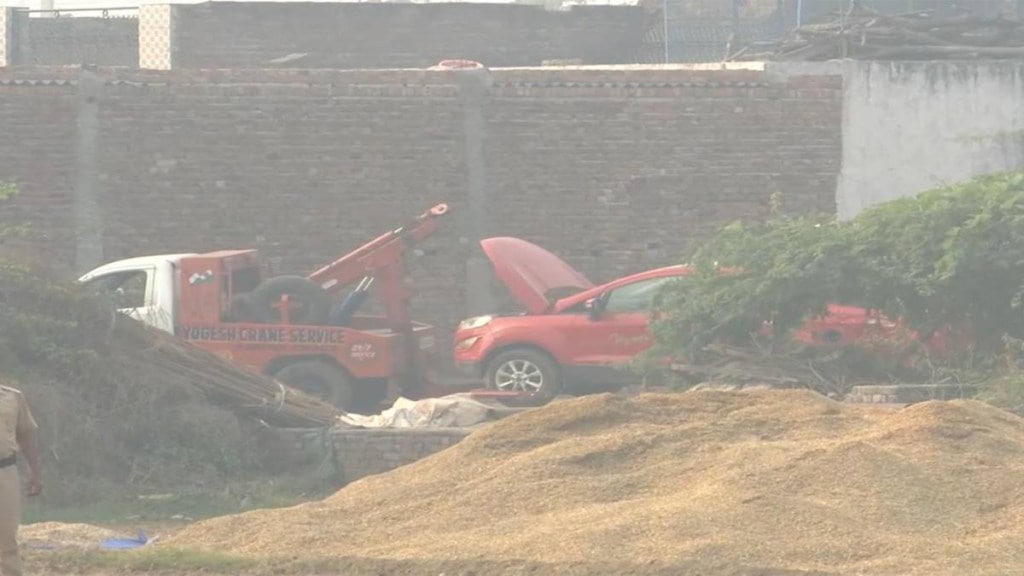 Police teams tow the suspect Ford car away. (Photo source: ANI) Police teams tow the suspect Ford car away. (Photo source: ANI)