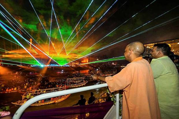 Uttar Pradesh Chief Minister Yogi Adityanath enjoys a laser show during Dev Deepawali celebrations, in Varanasi on Wednesday. (Photo source: ANI)