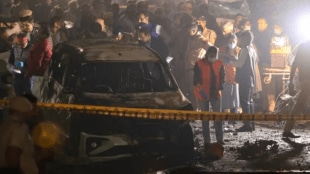 NIA personnel escort Jasir Bilal Wani, arrested from Srinagar, in connection with the Red Fort car bombing that killed 15 and injured over 30.