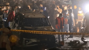 NIA personnel escort Jasir Bilal Wani, arrested from Srinagar, in connection with the Red Fort car bombing that killed 15 and injured over 30.