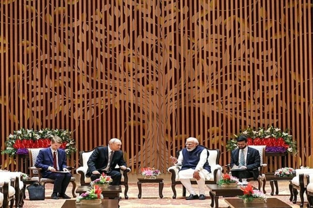 Prime Minister Narendra Modi and Russian President Vladimir Putin, during the India-Russia Business Forum, at Bharat Mandapam in New Delhi on Friday. (Image Source: ANI)